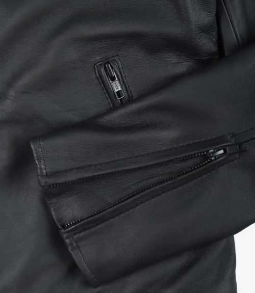 Close-up of a black leather jacket's sleeve with silver zippers. The texture appears smooth and sleek, suggesting a stylish, modern design.