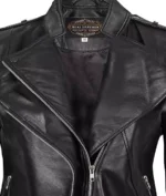 Close-up of a black leather jacket with silver zippers and a visible label inside the collar. The style is sleek and classic, conveying a cool, edgy tone.