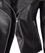 Close-up of a black leather jacket with prominent silver zippers, creating a sleek, edgy look. The shiny texture suggests a modern, stylish vibe.