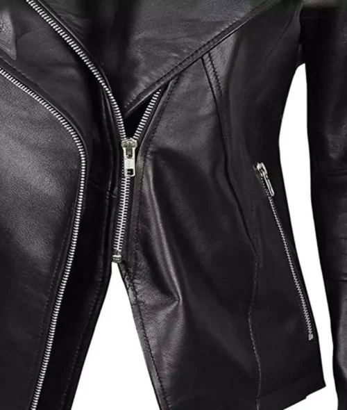 Close-up of a black leather jacket with prominent silver zippers, creating a sleek, edgy look. The shiny texture suggests a modern, stylish vibe.