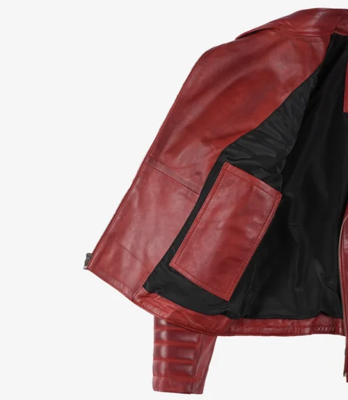 An open red leather jacket showing its black interior lining and a large inner pocket. The leather appears smooth, conveying a sleek and stylish tone.