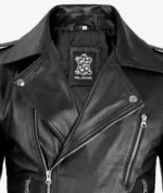 Close-up of a black leather biker jacket with silver zippers and studs, exuding a sleek and edgy style. Label inside reads Real Leather.