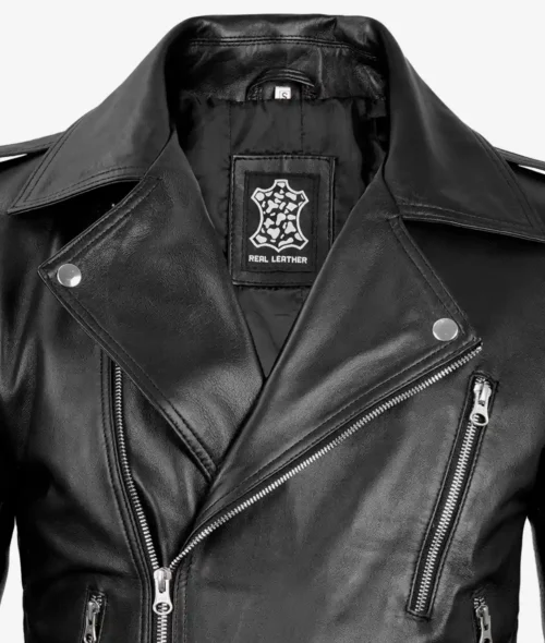 Close-up of a black leather biker jacket with silver zippers and studs, exuding a sleek and edgy style. Label inside reads Real Leather.