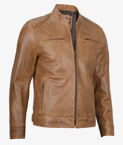 Tan leather jacket with a sleek design, featuring a front zipper, two horizontal chest pockets, and a stand collar. The tone is stylish and modern.