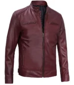 A burgundy leather jacket with a stand-up collar, front zipper, and two zippered chest pockets. The texture is smooth, conveying a sleek, modern style.