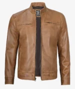 Tan leather jacket with a slim fit, featuring a stand collar, two chest pockets, and a front zipper. The material has a smooth, polished texture.