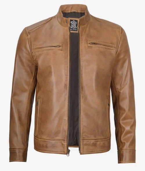 Tan leather jacket with a slim fit, featuring a stand collar, two chest pockets, and a front zipper. The material has a smooth, polished texture.