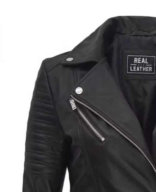 Close-up of a black leather jacket featuring a diagonal silver zipper and quilted shoulder pads. Inside label reads Real Leather. Rugged and stylish.