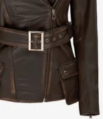 Dark brown leather jacket with a front zipper, silver buckle belt, and flap pockets. Offers a sleek, edgy look with a modern, rugged charm.