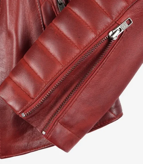 Close-up of a maroon leather jacket sleeve with detailed stitching and a visible silver zipper. The leather texture is smooth and slightly glossy.