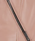 Close-up of a beige leather garment featuring a diagonal dark zipper with precise stitching, conveying a sense of style and elegance.