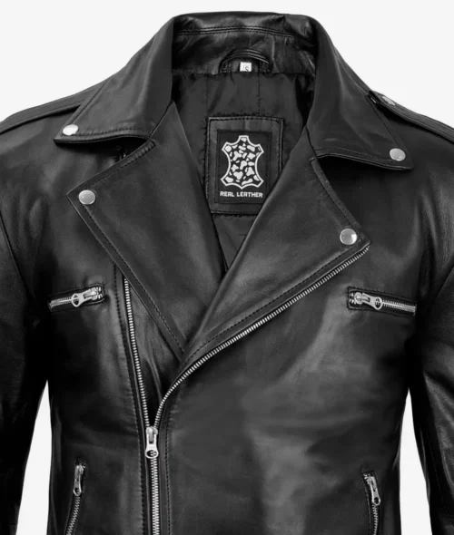 Black leather jacket with silver zippers and snap buttons, featuring a detailed label. The style is classic and sleek, evoking a sense of edgy sophistication.