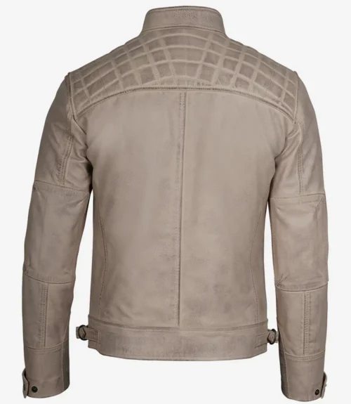 Back view of a taupe leather jacket with quilted stitching on shoulders. Features include a stand collar, adjustable waist tabs, and a sleek, modern design.