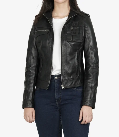 A person wearing a fitted black leather jacket over a white t-shirt and dark blue jeans. The jacket has multiple zippered pockets and a sleek, modern design.