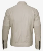 Back view of a beige leather jacket with ribbed panel details on sleeves and zipped cuffs. The sleek design suggests a modern and stylish tone.