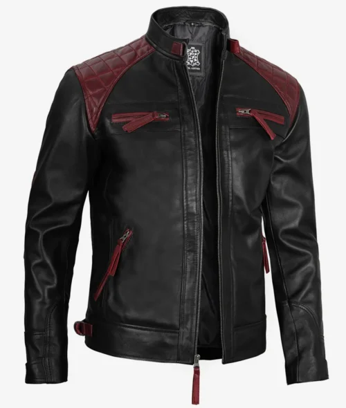 Black leather jacket with quilted burgundy accents on shoulders. Features zippered pockets and front zipper closure. Stylish and modern design.