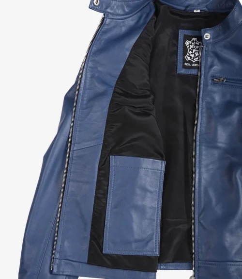 Open blue leather jacket showing its black lining and inner pocket. The label reads Real Leather. The zipper and snap button details are visible.
