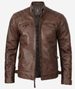 Brown leather jacket with quilted shoulders, zipped breast and side pockets. It has a high collar and open front, conveying a rugged, stylish look.