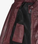 Open burgundy leather jacket showcasing its black inner lining and a large interior pocket. The jacket exudes a stylish, sleek tone.