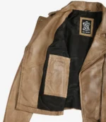 Tan leather jacket shown open, revealing black interior lining with a Real Leather label and an inner pocket. The tone is rugged and stylish.