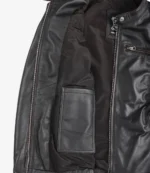 Open black leather jacket showing its interior. Features include a sleek lining, an inner pocket on the left, and a zippered pocket on the right.