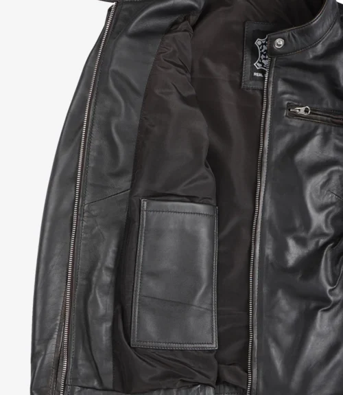 Open black leather jacket showing its interior. Features include a sleek lining, an inner pocket on the left, and a zippered pocket on the right.