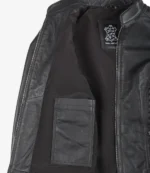 Open black leather jacket with interior view showing a label and a pocket. The zipper is partially visible, conveying a sense of style and durability.