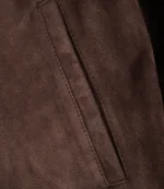 Close-up of pocket detail on dark brown suede leather jacket