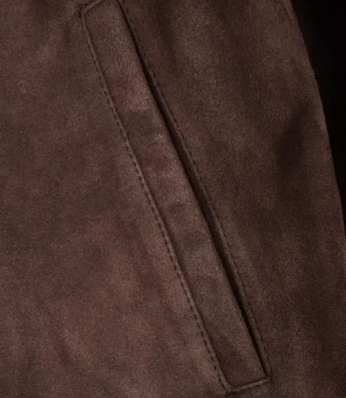 Close-up of pocket detail on dark brown suede leather jacket