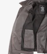 Brown leather jacket with inner black lining and a "Real Leather" label. The jacket has bronze snap buttons, creating a classic and rugged feel.