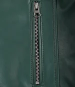 Close-up of a green leather jacket with a silver zipper running vertically. The texture is smooth, and the sleek design conveys a modern, stylish look.