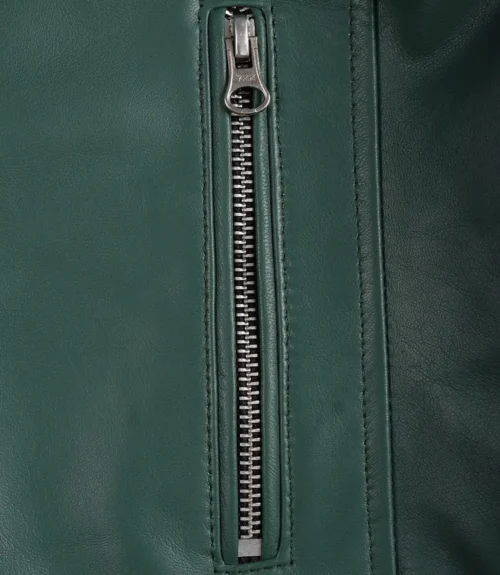 Close-up of a green leather jacket with a silver zipper running vertically. The texture is smooth, and the sleek design conveys a modern, stylish look.
