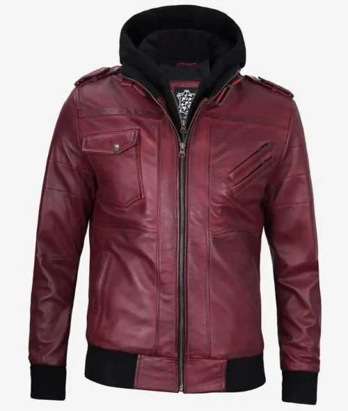 A maroon leather jacket with black ribbed cuffs and hem, featuring zippered and buttoned pockets. The jacket has a detachable black hood, creating a stylish, edgy look.