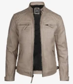 Beige leather jacket with a quilted pattern on shoulders, zippered chest pockets, and a sleek design. Black inner lining adds contrast.