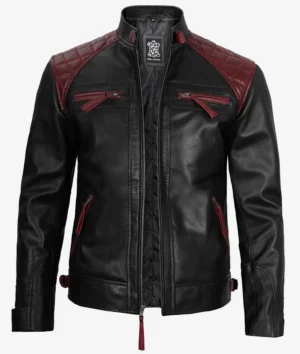 Black leather jacket with maroon quilted shoulders and accents, featuring zippers on the chest and sides. The design conveys a stylish, edgy tone.