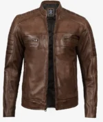 Brown leather jacket with a sleek design, featuring quilted shoulders, a front zip, and two zippered chest pockets, conveying a stylish, rugged look.