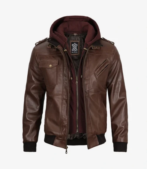 Brown leather jacket with a detachable hood in maroon, featuring multiple zippered pockets, shoulder epaulettes, and ribbed cuffs, conveying a rugged style.
