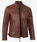 Brown leather jacket with a sleek design, featuring zippered chest and side pockets, a front zipper closure, and quilted shoulder detailing. Classic and stylish tone.