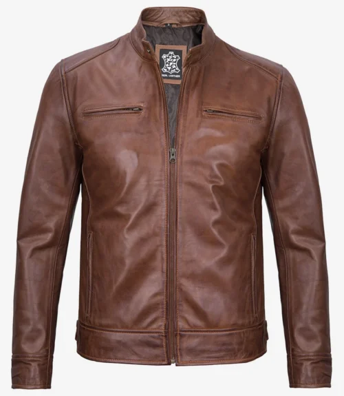 Brown leather jacket with a stand-up collar and front zipper. Features chest pockets and smooth texture, conveying a stylish, classic look.