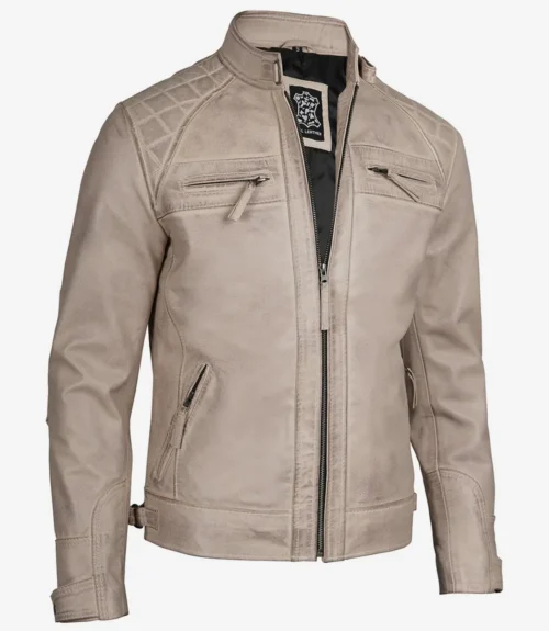 Beige leather jacket with a high collar and quilted shoulder design, featuring zippered chest and side pockets. The jacket conveys a stylish, rugged look.