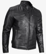 Black leather motorcycle jacket with a high collar, zippered front, and zippered pockets. The smooth texture and sleek design convey a cool, edgy vibe.