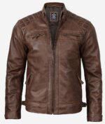 Brown leather jacket with a front zipper, quilted shoulders, and four zippered pockets. The style is rugged and modern, exuding a classic biker vibe.