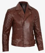 Brown leather jacket with quilted shoulder design, zipped pockets, and buckle accents on the sides. The jacket has a rugged and stylish look.