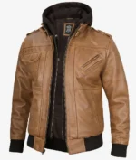 A stylish brown leather jacket with black elastic cuffs and a zipper, featuring multiple pockets and a black hoodie underneath, conveying a rugged, casual look.
