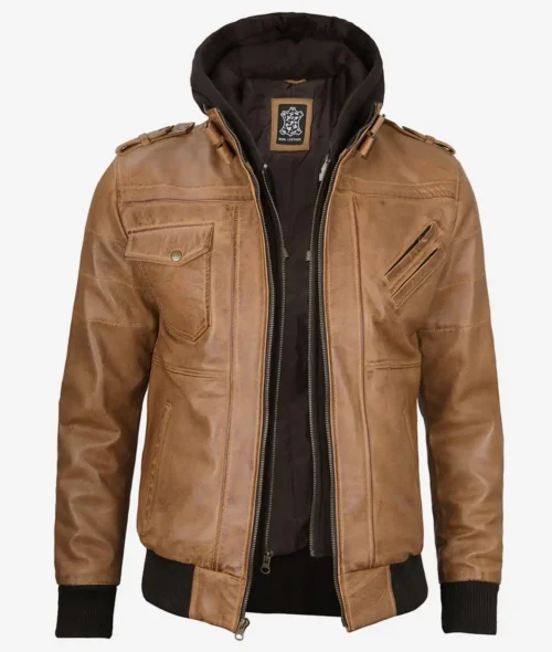 Brown leather jacket with a front zipper, two flap pockets, and ribbed black cuffs. It includes a detachable black hoodie for a casual, stylish look.