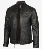 Black leather jacket with a sleek, rugged design, featuring zippered chest pockets and quilted shoulders. It conveys a stylish, edgy vibe.