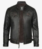 A sleek black leather jacket displayed against a white background. It features a high collar, zippered chest pockets, and a stylish quilted pattern on the shoulders.