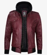 Maroon leather jacket with multiple pockets and zip details, featuring a black hooded insert. Exudes a stylish and edgy vibe.
