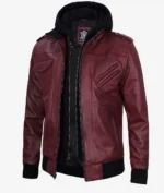A maroon leather jacket with a black zippered hoodie. The jacket features multiple zip pockets and shoulder epaulets.