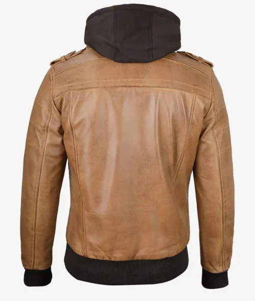 Back view of a tan leather jacket with a detachable black hood. The jacket features shoulder epaulettes and ribbed cuffs and hem, conveying a casual yet stylish look.